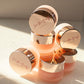 Set of skincare jars with rose gold lids on a light background