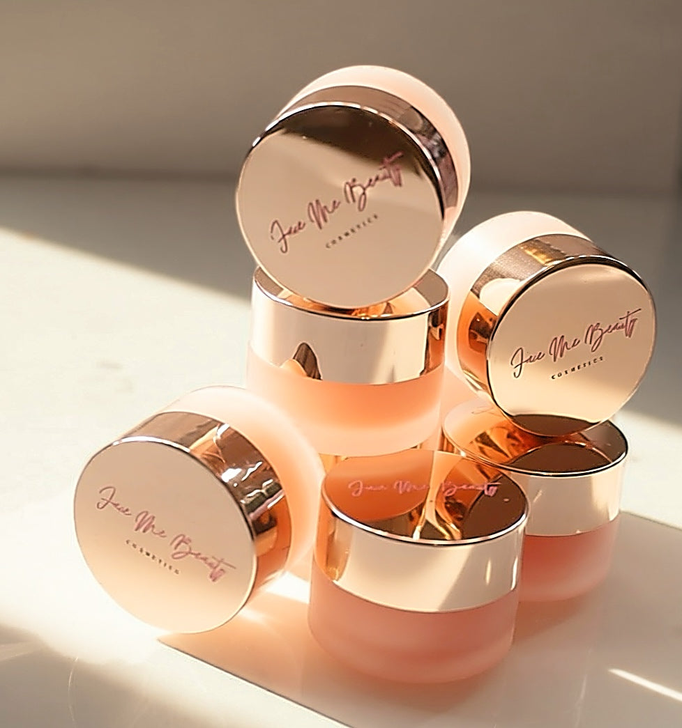 Set of skincare jars with rose gold lids on a light background