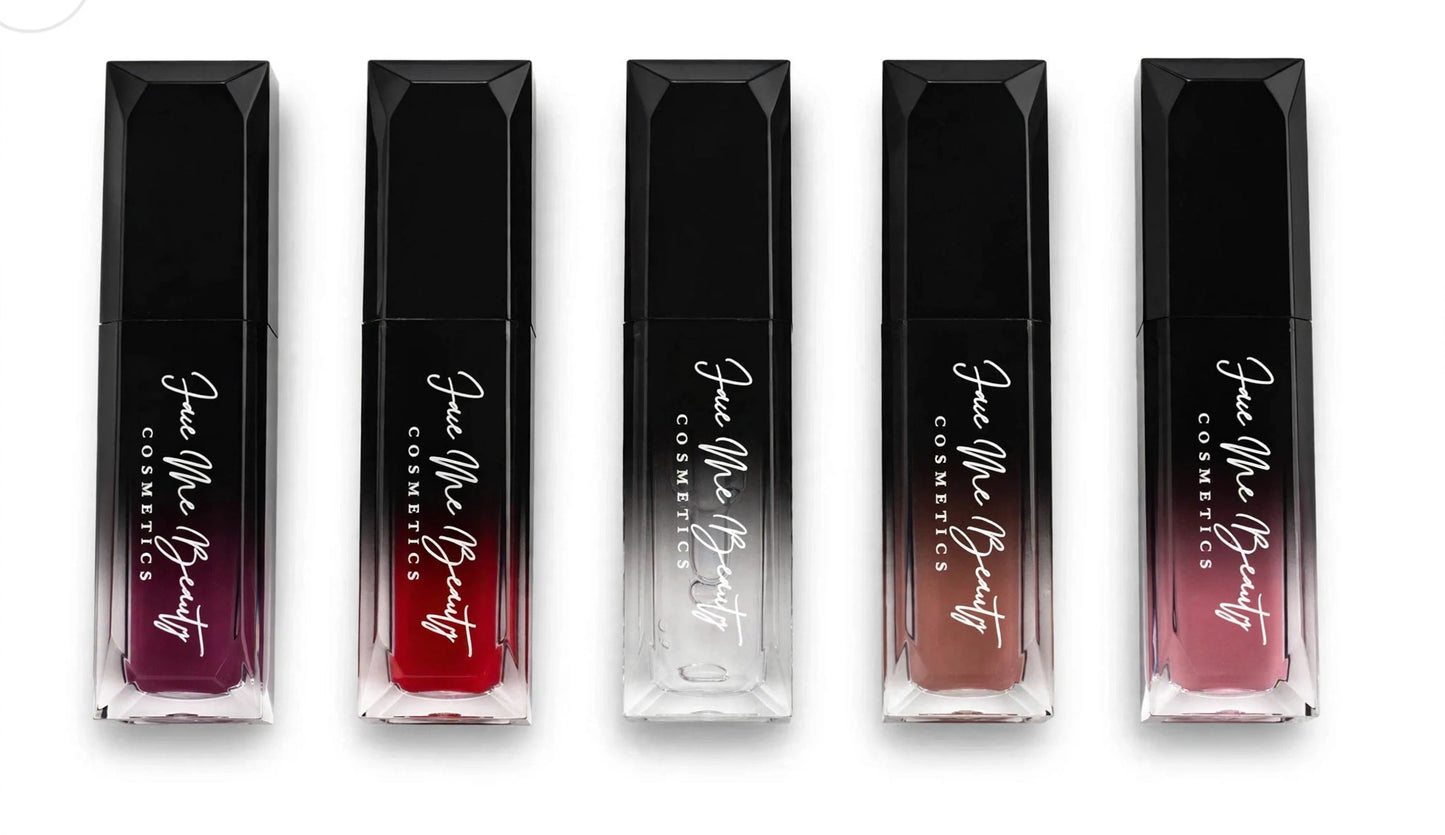 Five Face Me Beauty Cosmetics liquid lipstick tubes in a row on a white background, showing gradient shades from deep purple to red, nude, and rosy pink.
