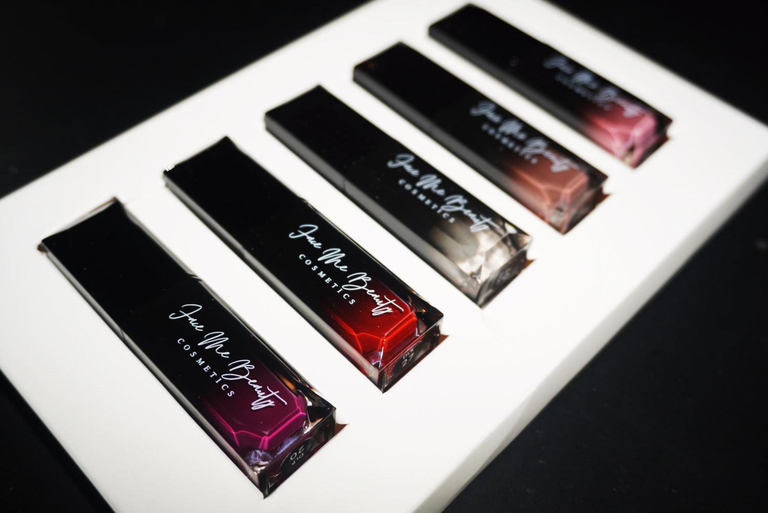 Set of lip gloss packaging with FMB on a white background