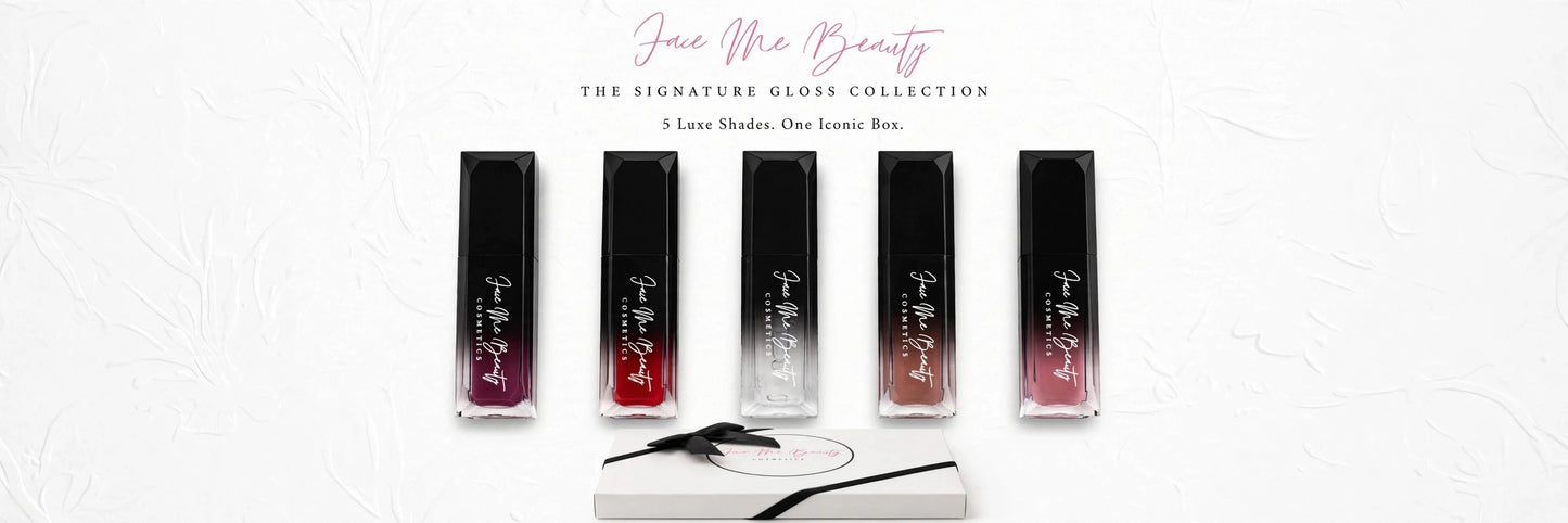 Five Face Me Beauty lip gloss tubes in a row on a white textured background, with three shades showing red-to-clear gradient glosses and two black tubes. A white box and black applicator are placed below the products.