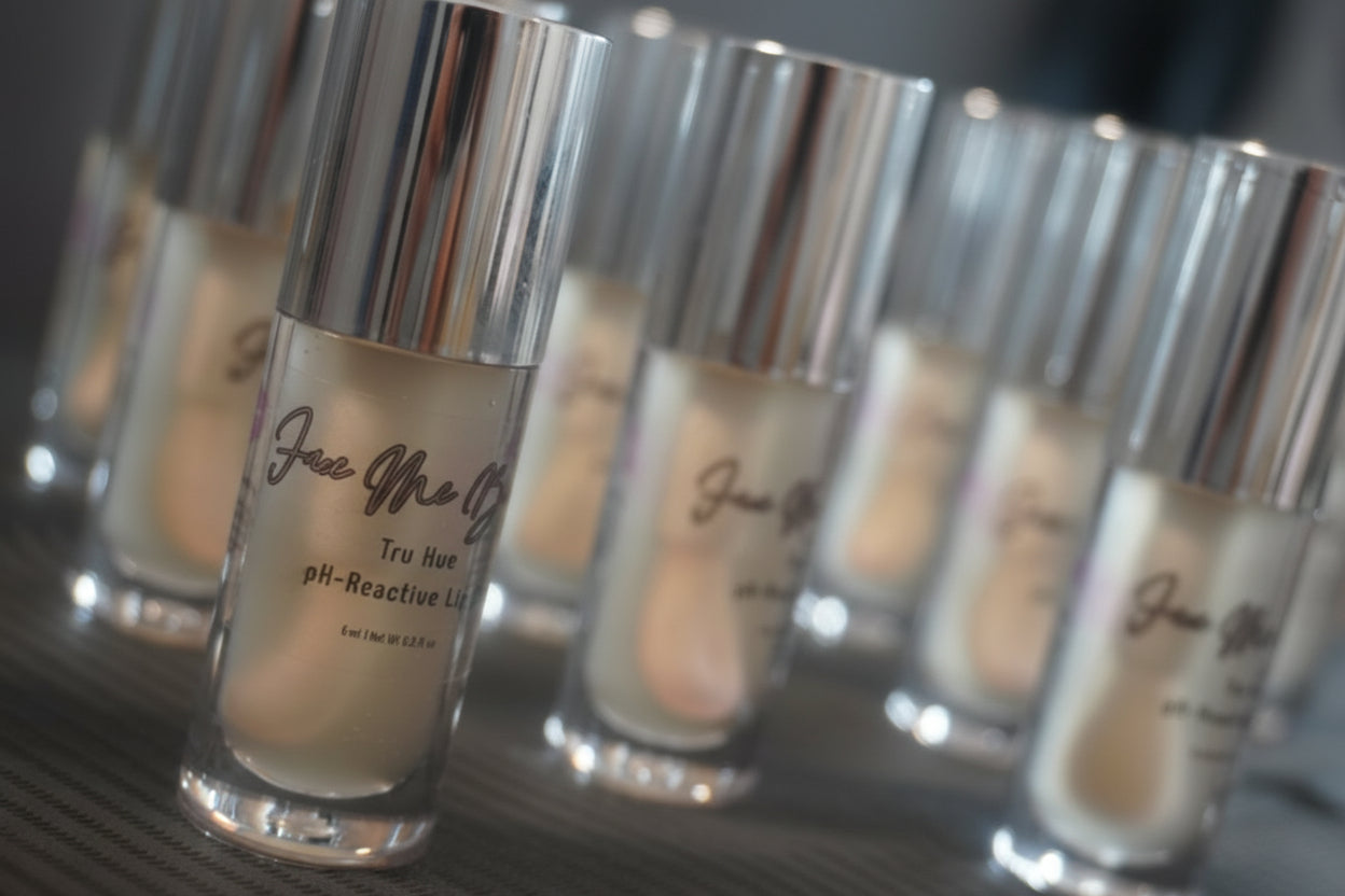 Row of skincare bottles with visible labels on a reflective surface